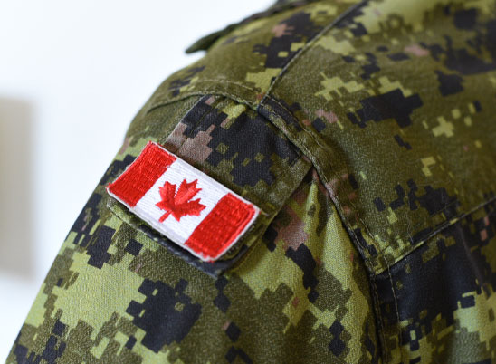 A closeup of the shoulder of a Canadian Armed Forces uniform with a Canadian flag patch.