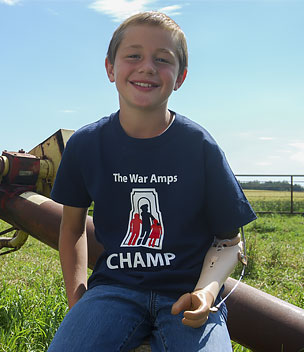 Champ Ernie, an arm amputee, posing in front of a grain auger.